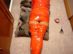 My girlfriend lays on the floor, wrapped into red tape, so that she depends on me. I give you some closeups of her.