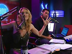 Playboy Radio's Morning Show has some of the hottest hotties you've ever seen! They're talking about Halloween costumes, and their guest has a cop outfit on that looks hawt as hell. It gets even sexier when her top comes off, baring her tits. The female host comes over and helps shorten the skirt.