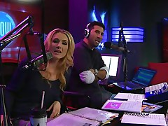 The hosts of Playboy Radio's Morning Show are looking at their guest model who is wearing the costume she'll be wearing to the Playboy Mansion for Halloween. Her head and tits are overspread in fake fruit like oranges, limes, lemons, and more. She flashes her pointer sisters for the hosts and viewers.